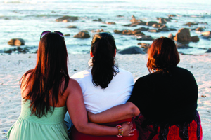 iStock_000019848651SMALL Three woman at the beach looking into the ocean