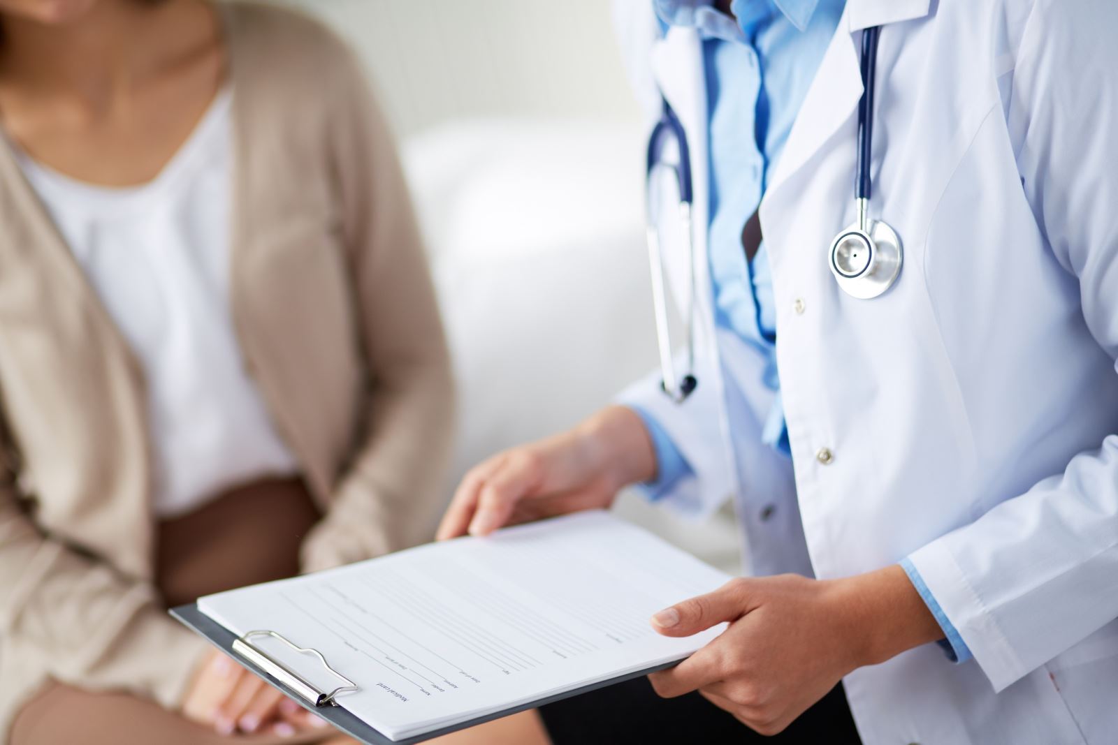 Doctor service Doctor holding a clipboard seeing a patient