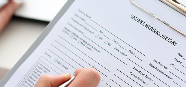 Female doctor hold clipboard pad Female doctor hold clipboard pad filling out a Patient medical history form