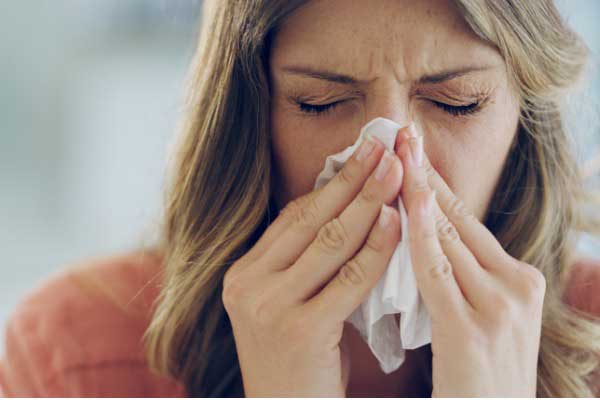 Sick girl blowing her nose