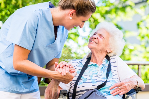 Nurse holding hand of senior woman in pension home Nurse holding hand of senior woman in pension home